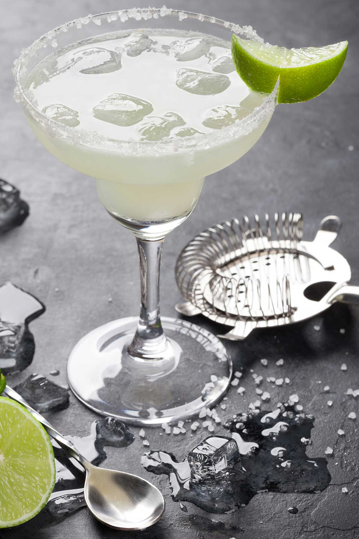 cadillac margarita in a glass with a lime wedge