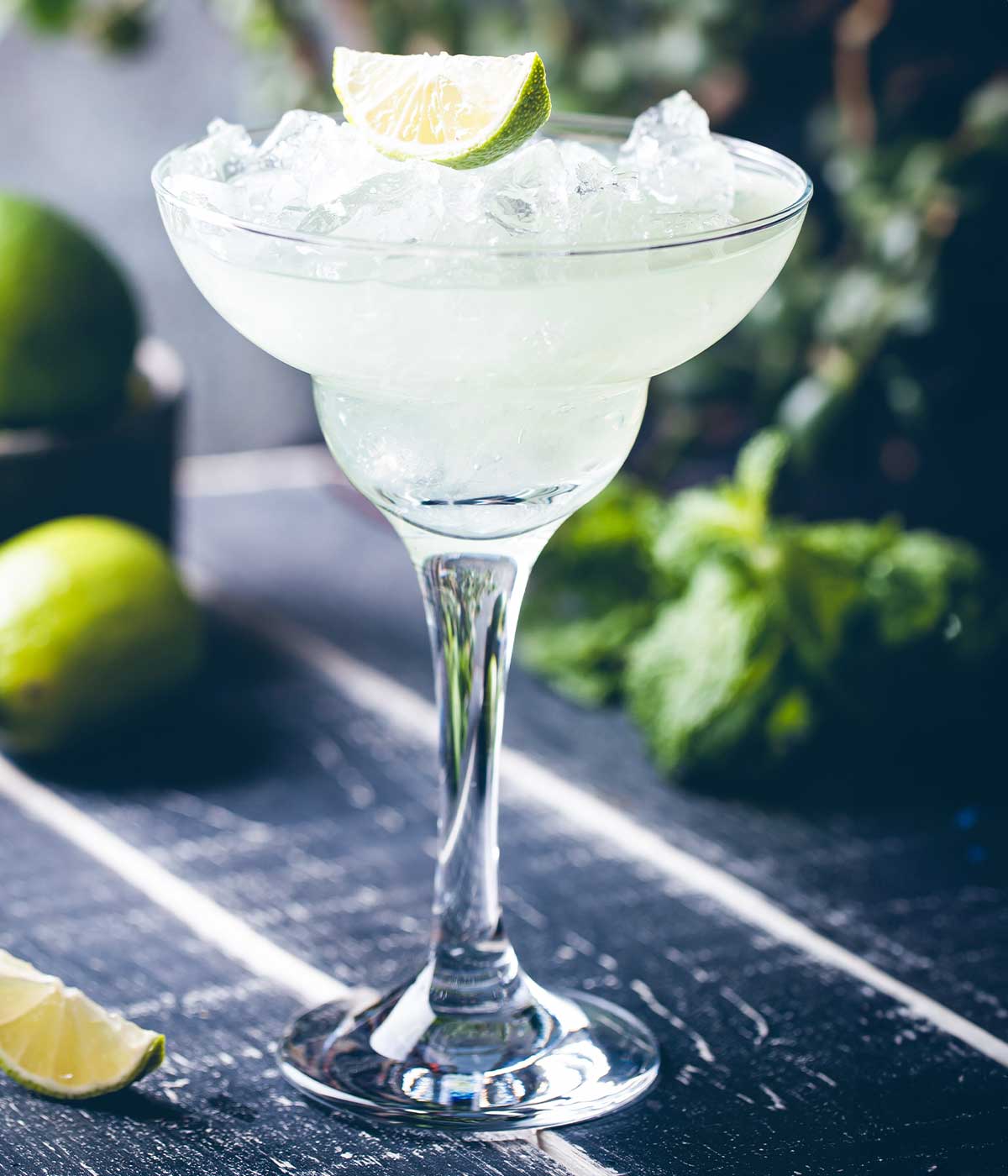 cadillac margarita in a glass with a lime wedge