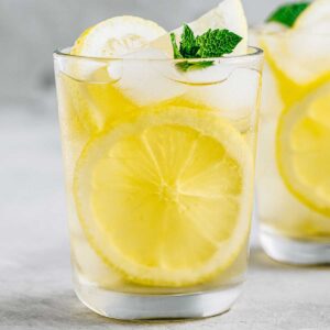 a glass of tequila with lemonade