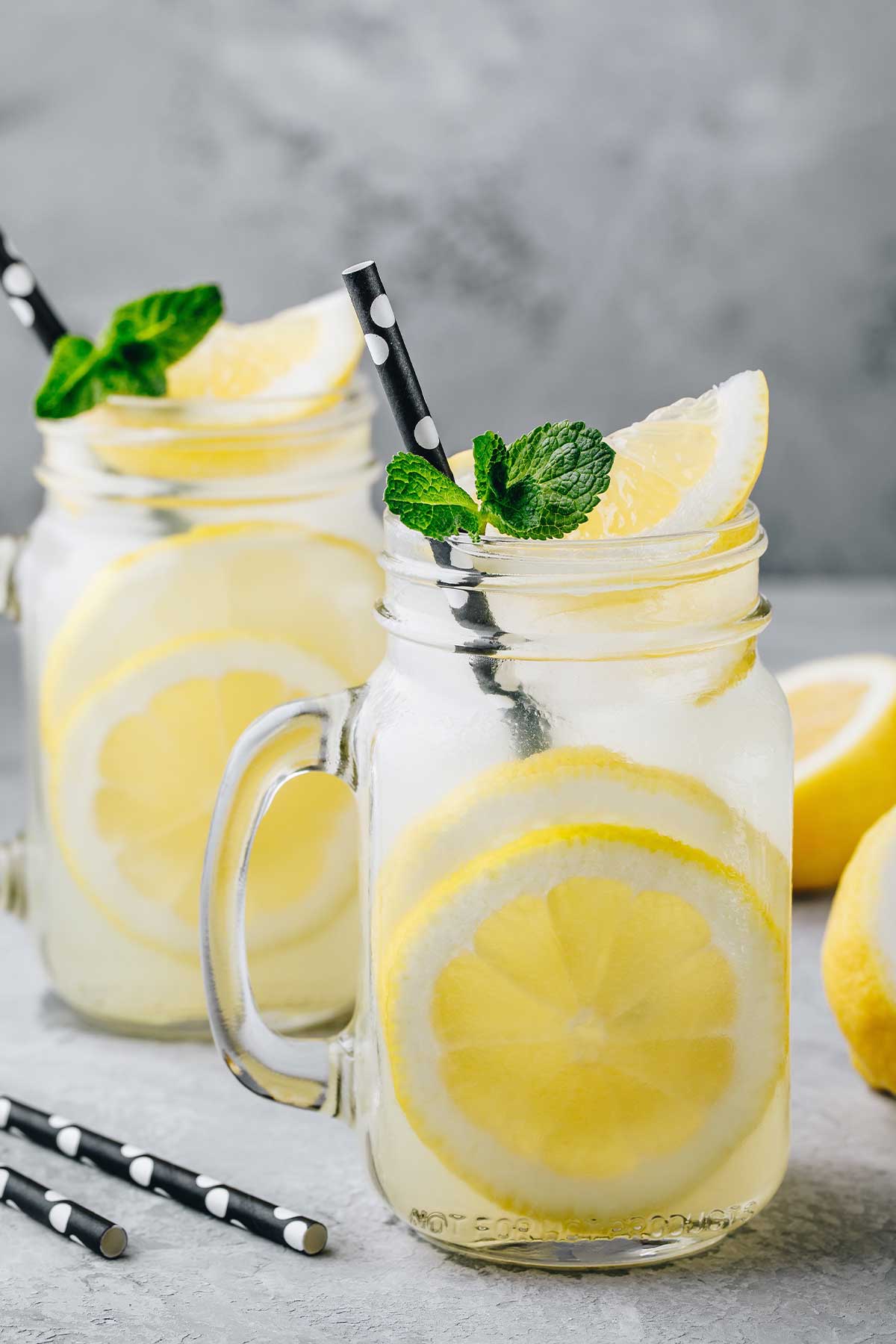 two glasses of tequila lemonade and some lemons around