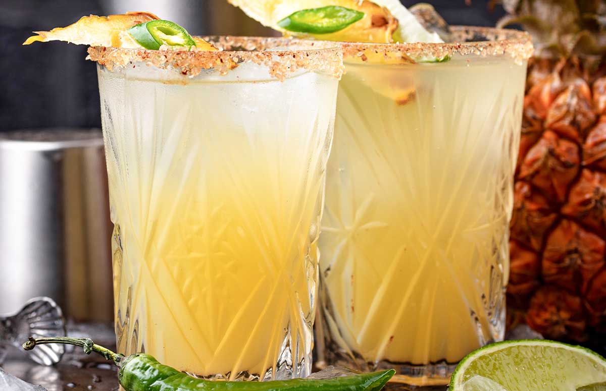 two glasses of pineapple jalapeño margarita