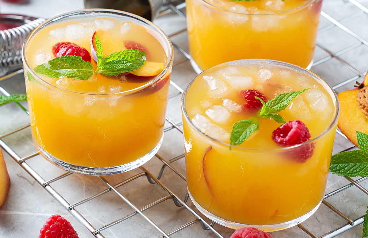 two peach margaritas ready to be served