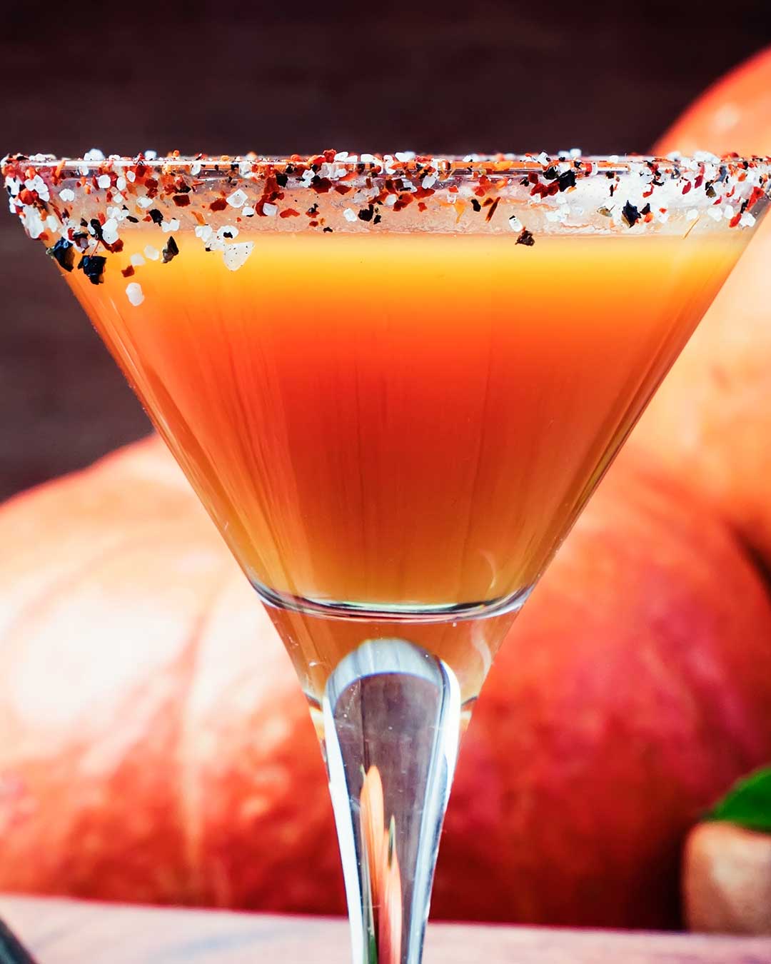 Close up of a Halloween Cocktail with Tequila, rimmed with Halloween sanding sugars.