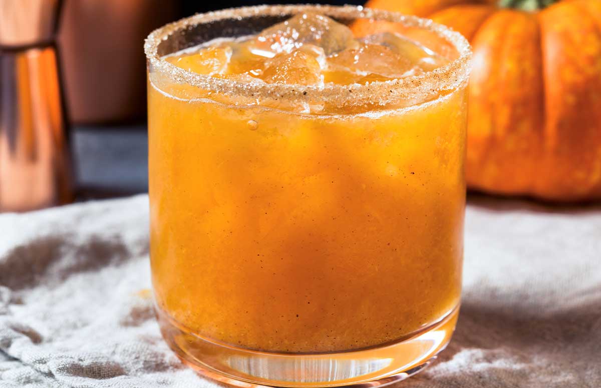 closeup of a short glass of an orange pumpkin margarita