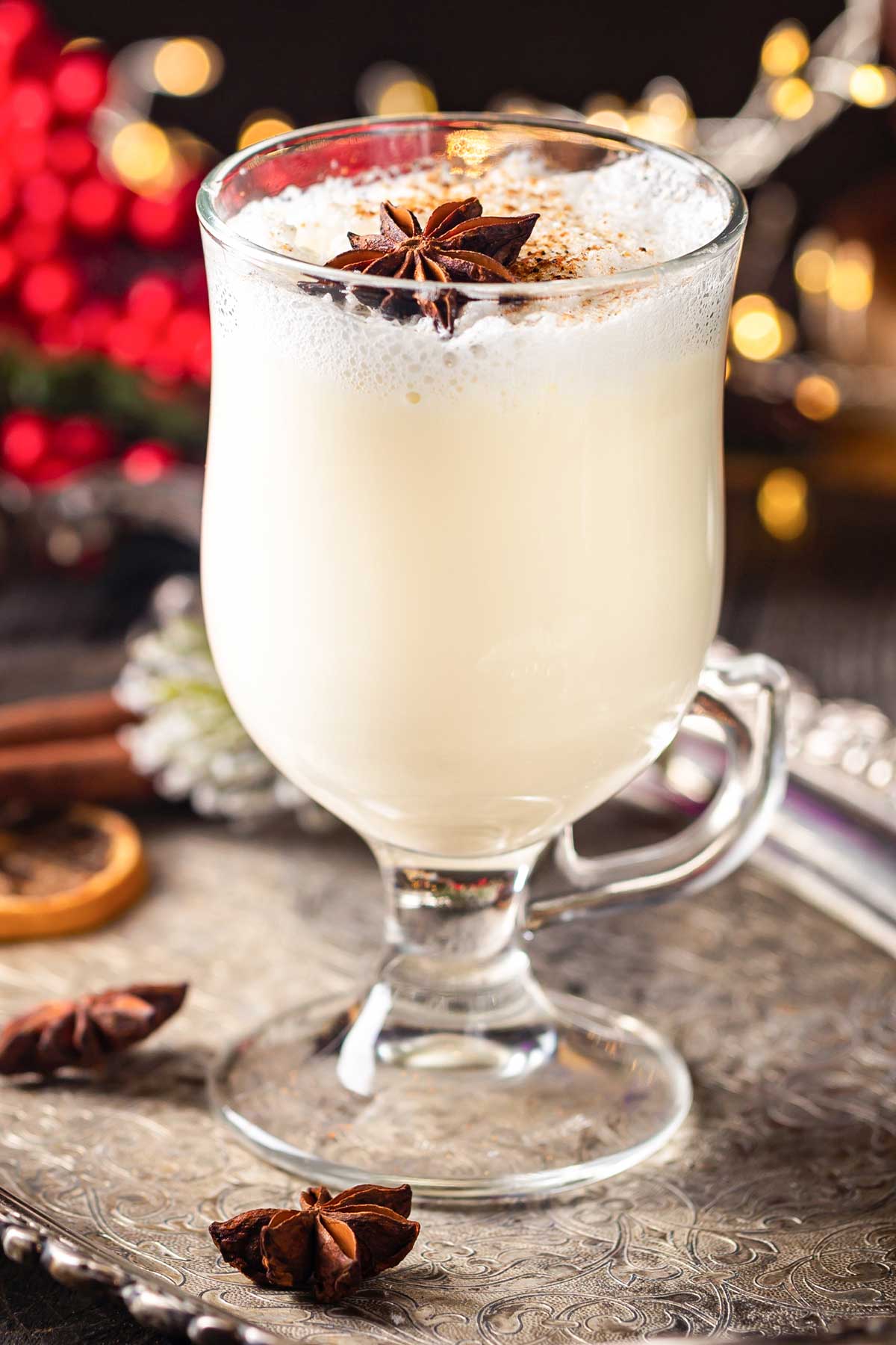 large glass of eggnog and tequila with Christmas garnish