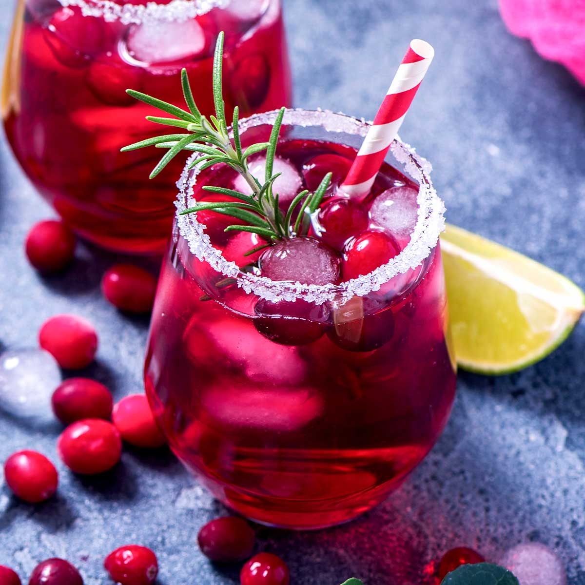 pink mistletoe margarita with a striped straw