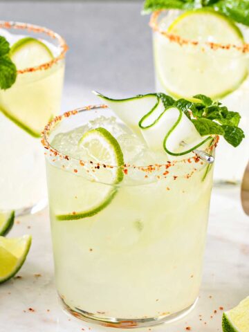 Spicy cucumber margarita in a glass with ice and cucumber slices