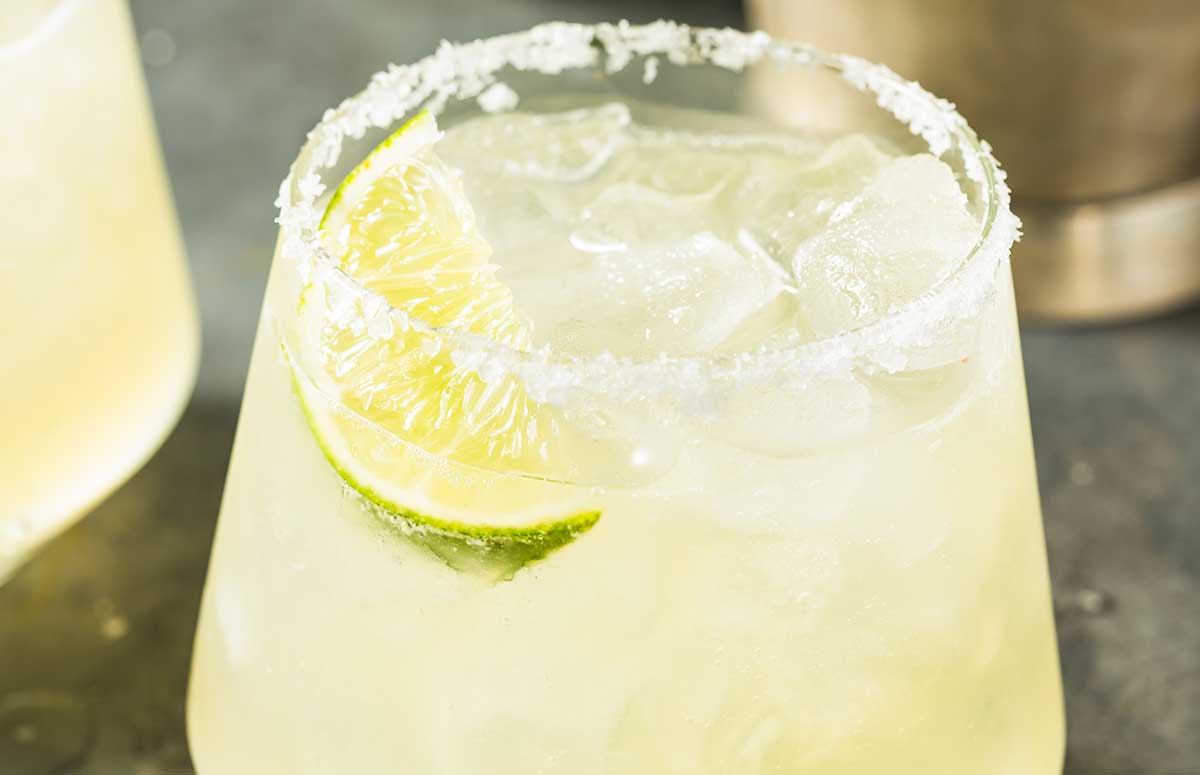 Elderflower Margarita with salted rim and lime wedge.