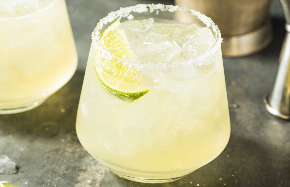 Elderflower Margarita with salted rim and lime wedge.