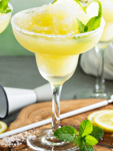 Frozen Skinny Margaritas with lime slices and mint.