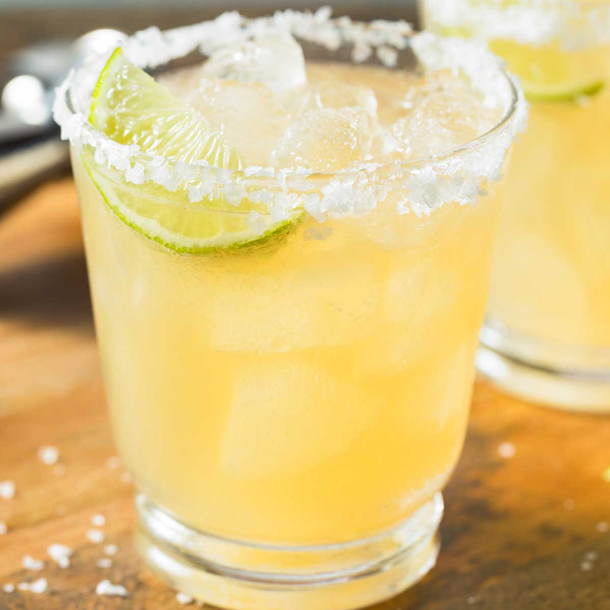 Skinny Mezcal Margarita with salted rim and lime wedge.