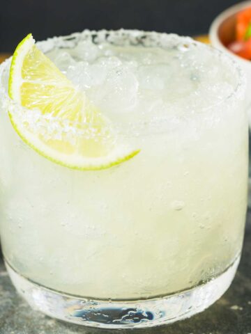 Sugar free margarita with a lime wedge and salted rim