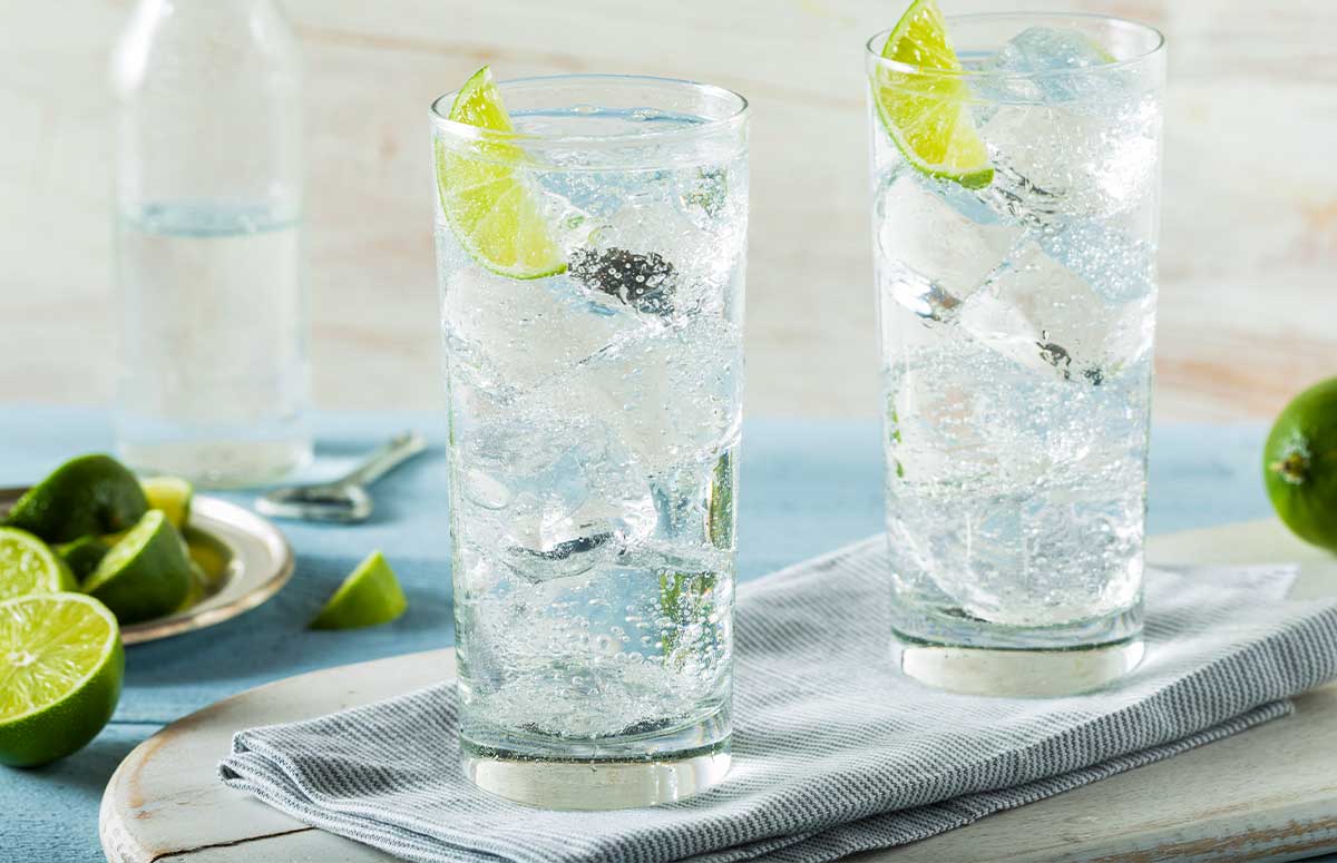 two glasses of tequila ranch water garnished with lime