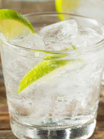 tequila soda cocktail with a lime wedge.