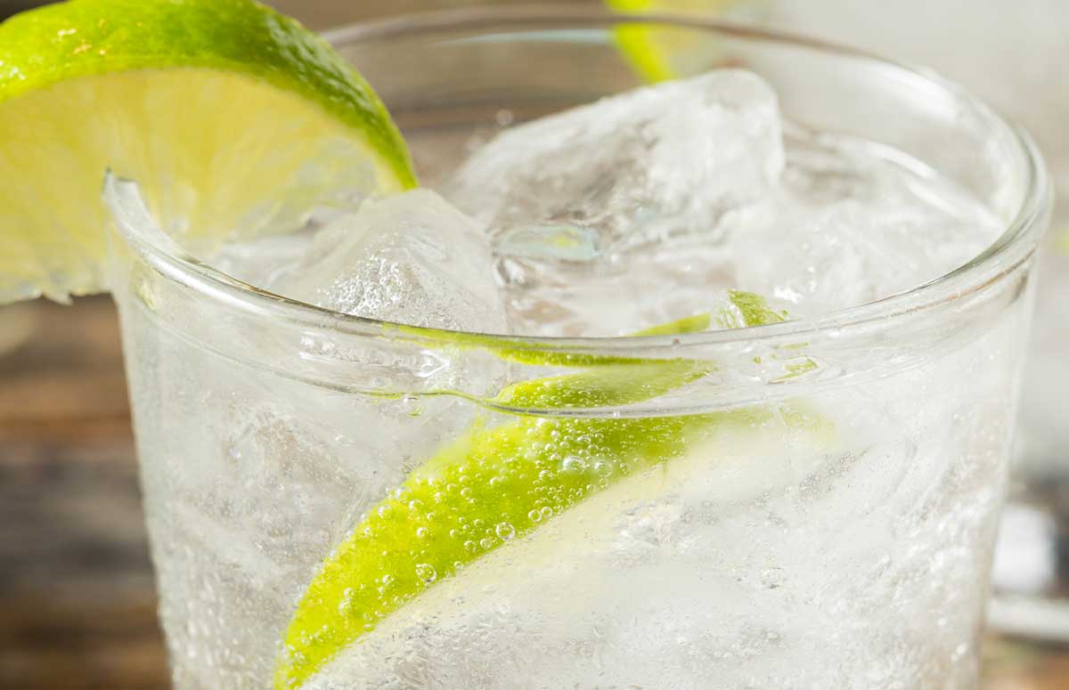 tequila soda cocktail with a lime wedge.