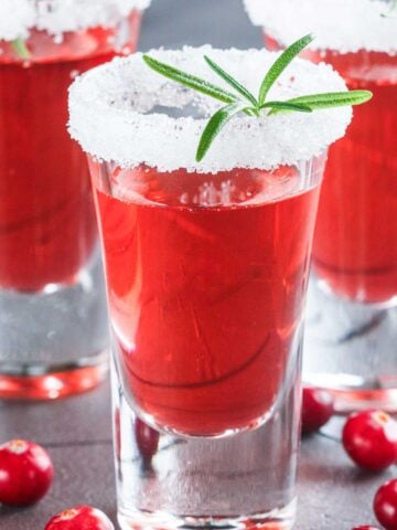 red tequila shots with a white sugar rim and a green garnish