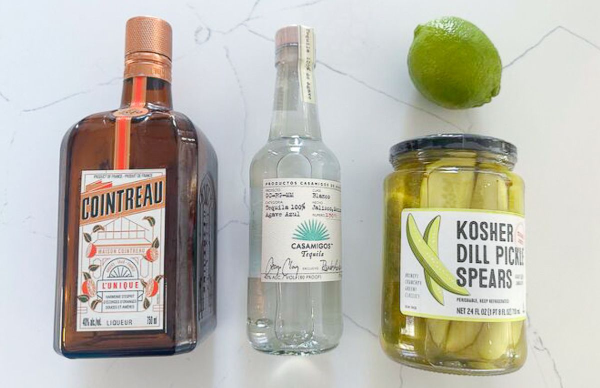 pickle margarita with a lime wedge and pickle spear