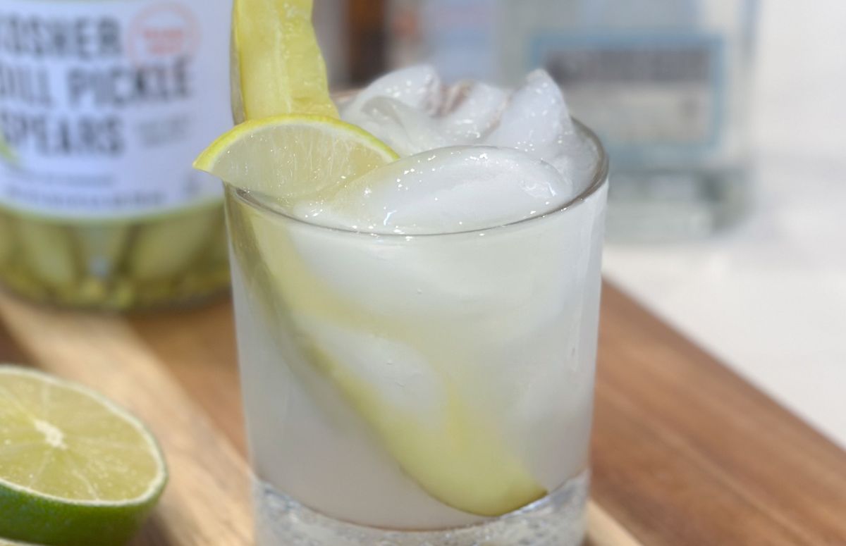 pickle margarita with a lime wedge and pickle spear