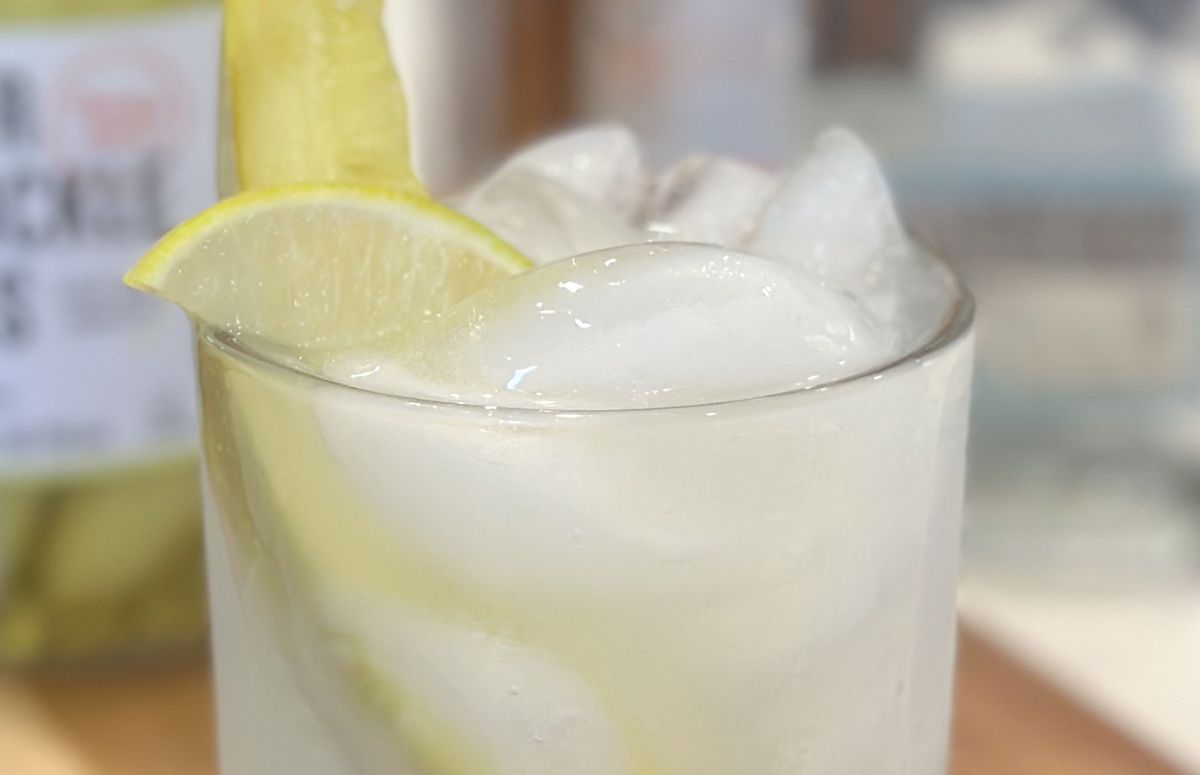 pickle margarita with a lime wedge and pickle spear