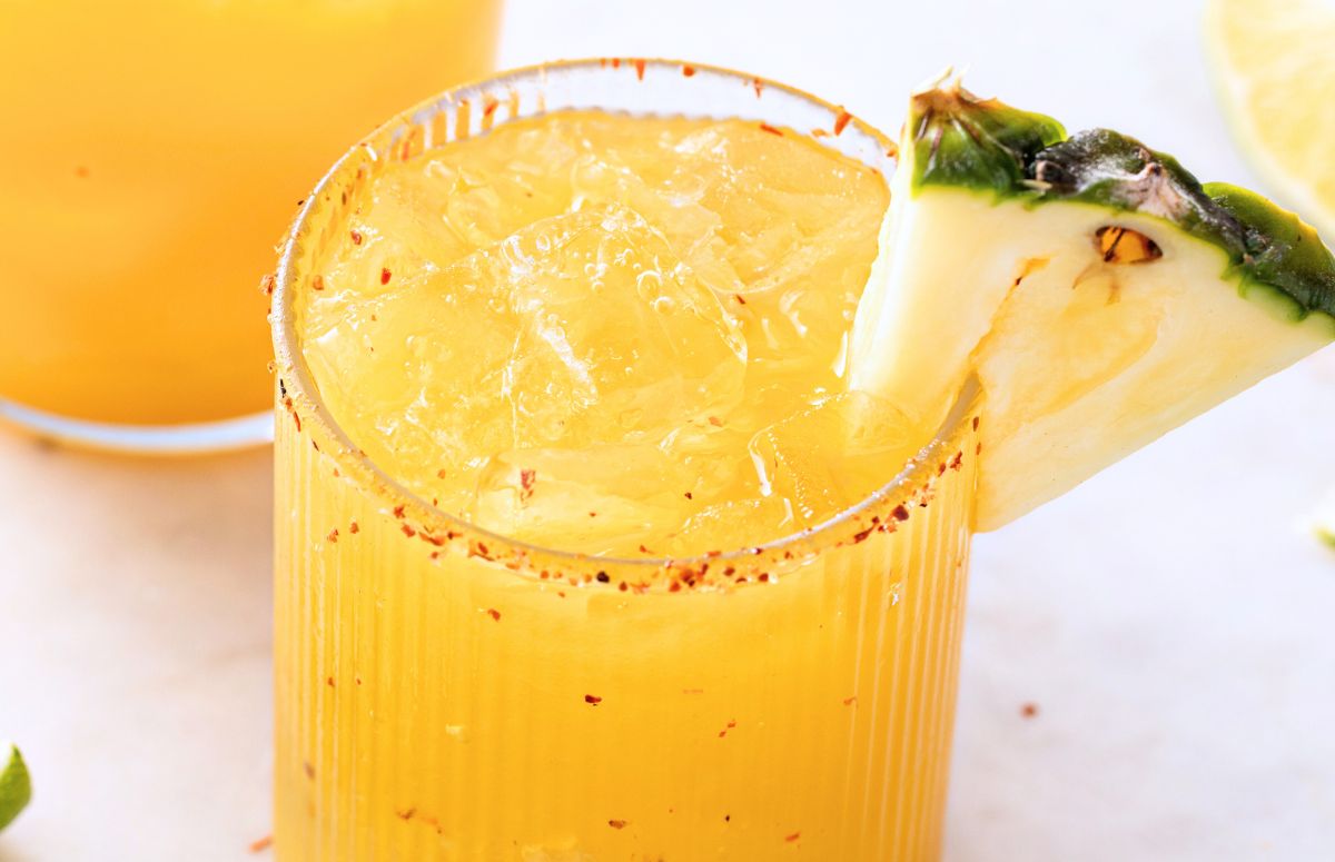 pineapple mezcalita with a tajin rim and a pineapple slice