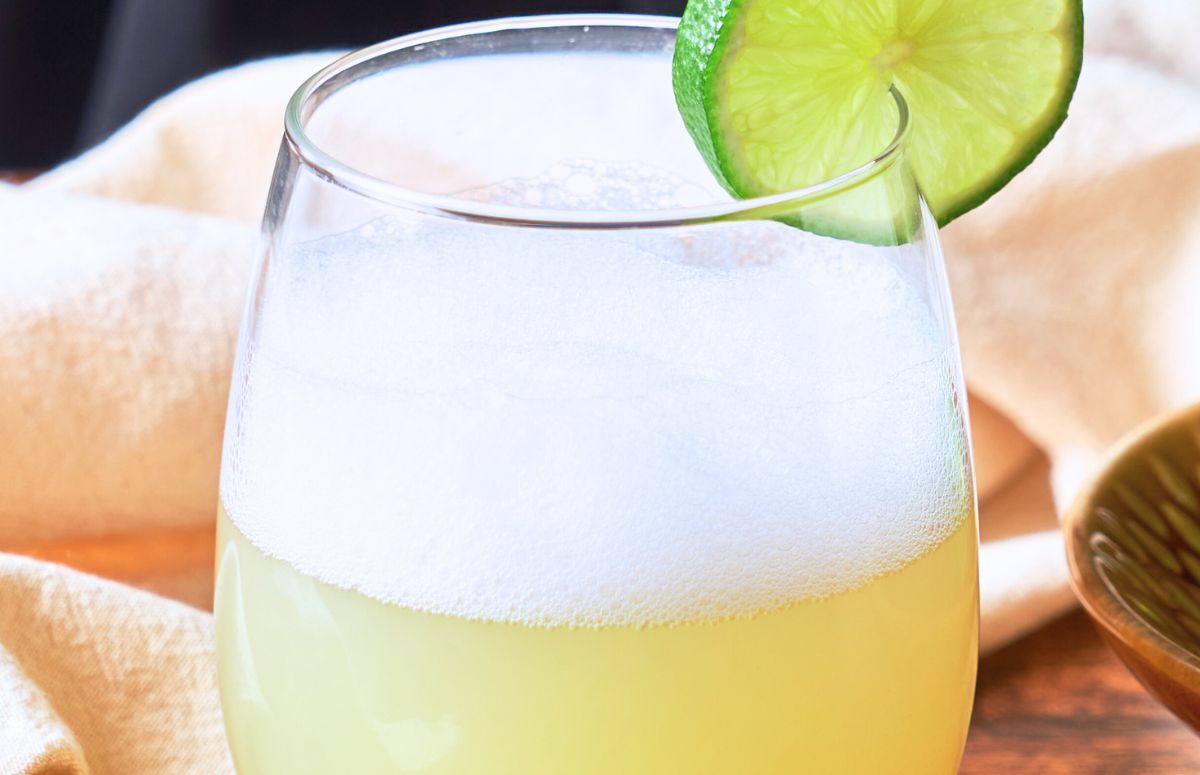 Mezcal Sour with a lime slice