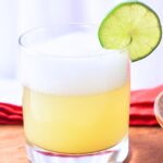 tequila sour cocktail with a lime slice