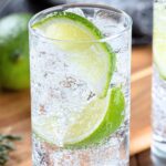 Tequila and Sprite cocktail with a lime wedge