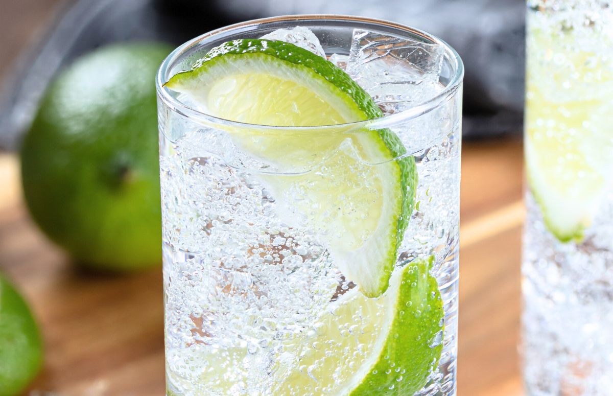 Tequila and Sprite cocktail with a lime wedge