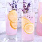lavender lemonade cocktail with tequila, lemon slices and edible flowers