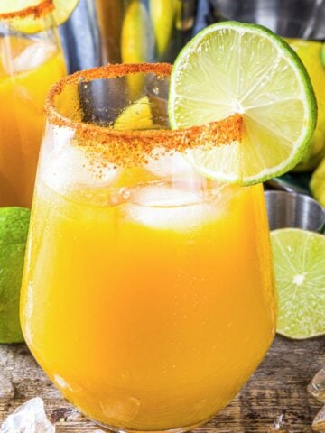 spicy mango margarita with tajin and lime slice