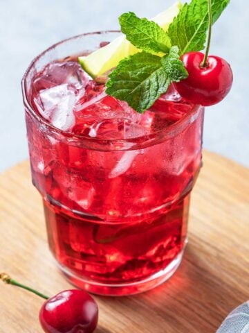 A tequila dirty shirley cocktail in a glass