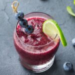 frozen blueberry margarita in a glass