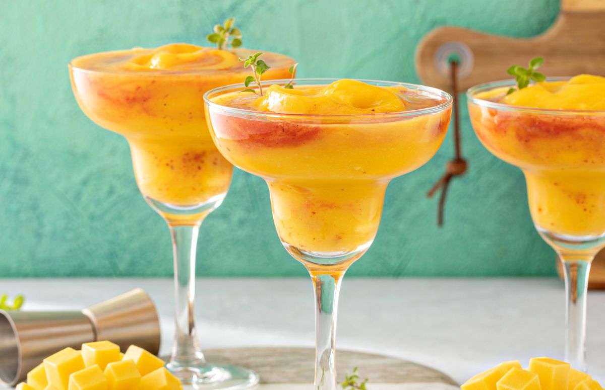 three frozen mango chili margaritas