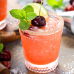 a glass of frozen cherry limeade margarita