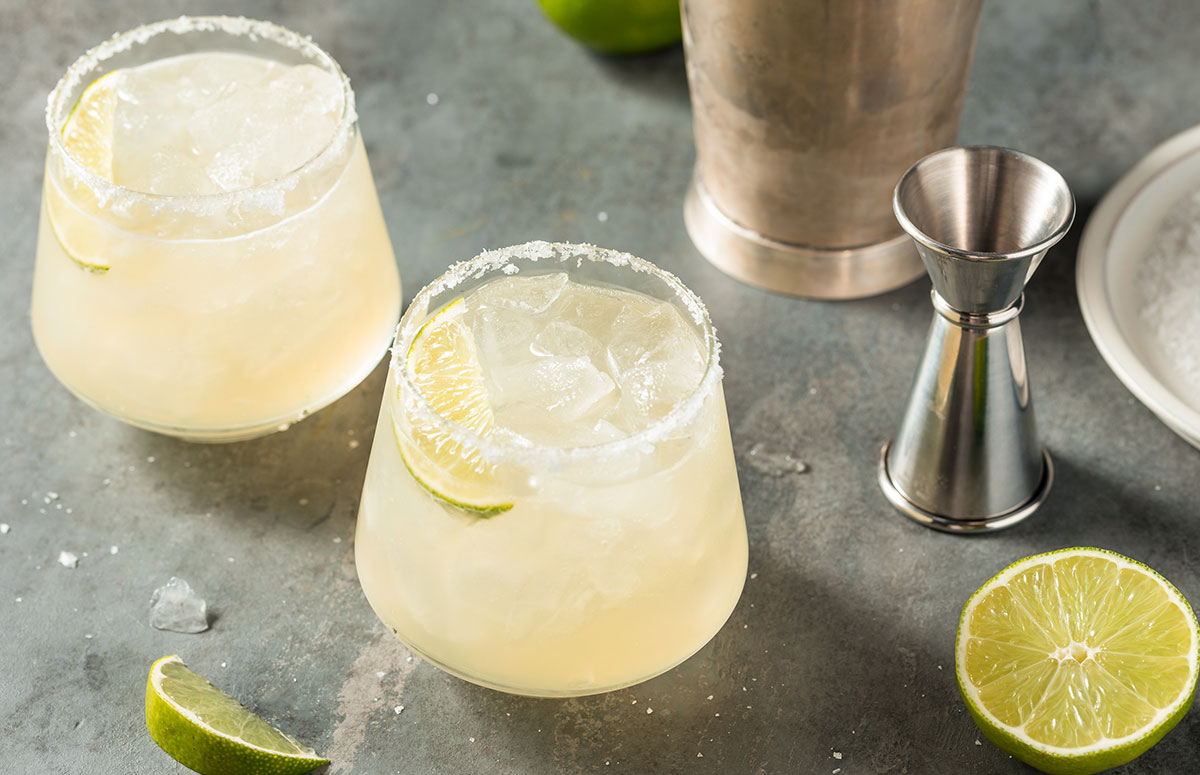 two glasses of reposado margarita and a jigger