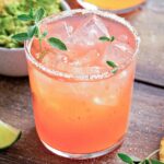 a glass of papaya margarita